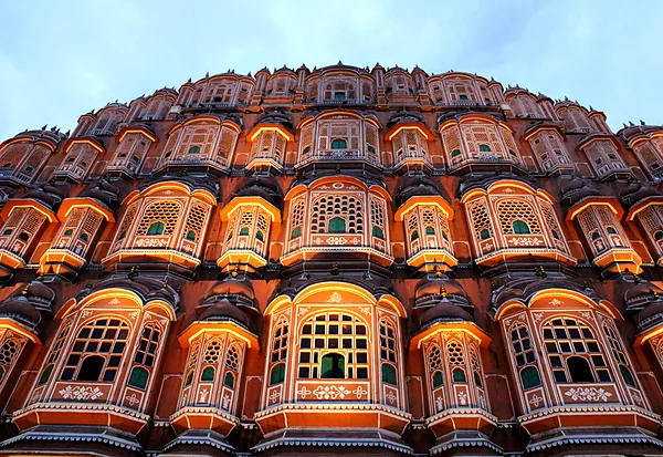 The honeycomb facade of Hawa Mahal glowing at dusk, Jaipur