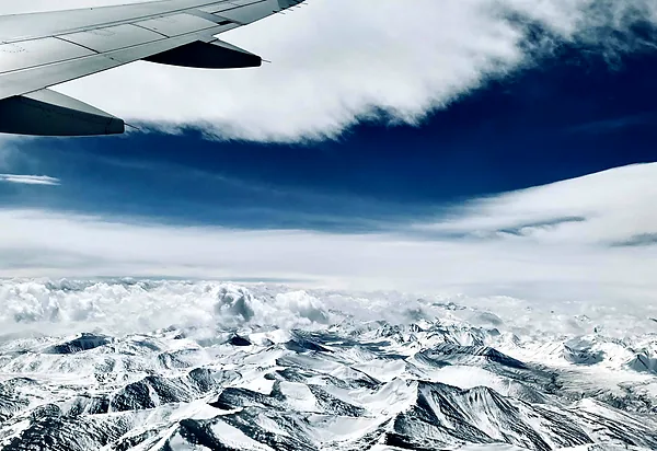Snow-covered Himalayan ranges seen from a plane window