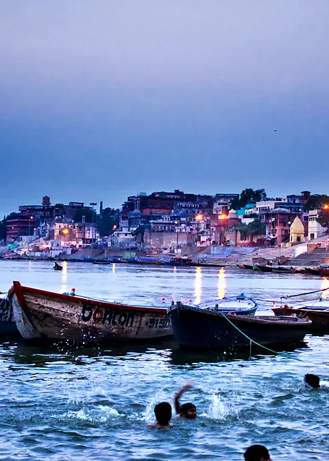 Boats on the Ganges at the ghats of Varanasi at dusk